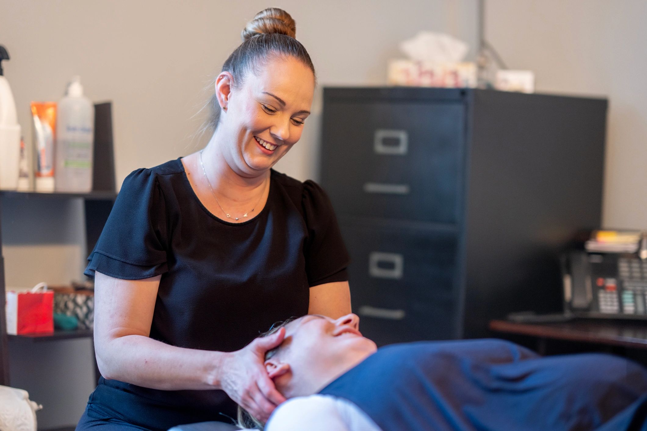Professional therapist providing a gentle wellness treatment