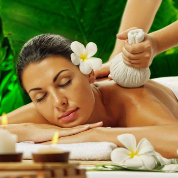 Relaxation massage with flowers and towels in a peaceful spa setting